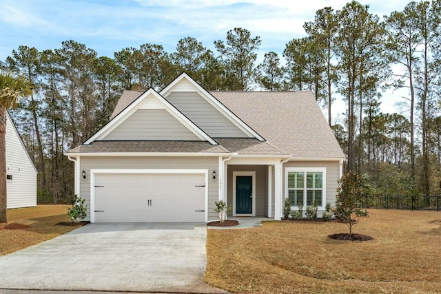 view of front facade with a garage, concrete driveway, roof with shingles, and fence