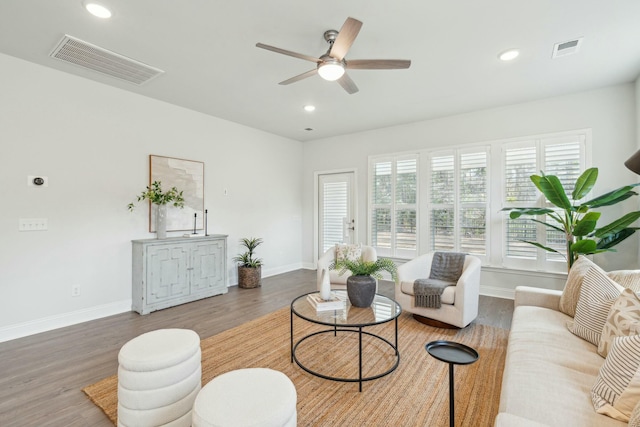 living area with recessed lighting, visible vents, and wood finished floors