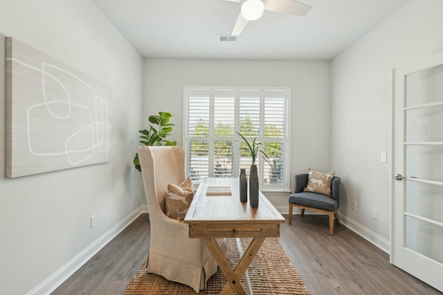 home office with wood finished floors, visible vents, and baseboards