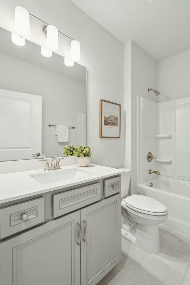 bathroom with washtub / shower combination, tile patterned flooring, vanity, and toilet