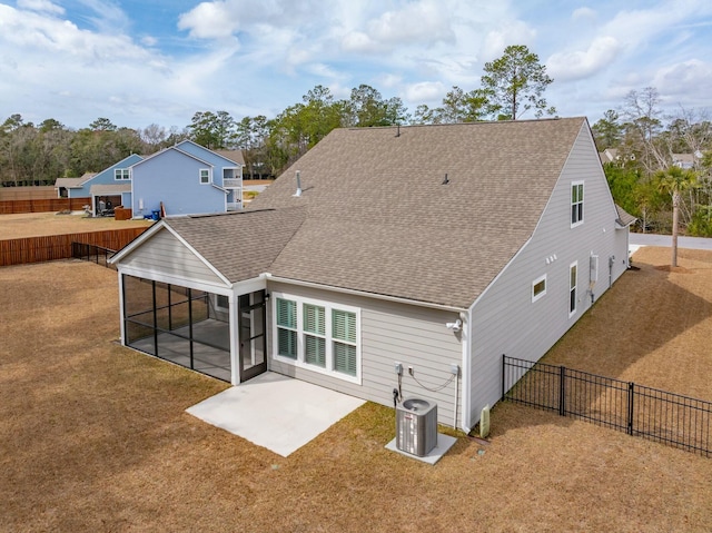 back of property featuring a sunroom, a patio area, fence, and roof with shingles