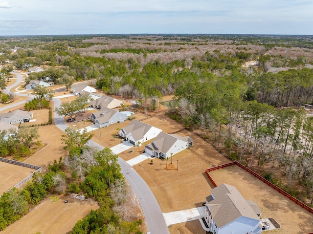 drone / aerial view with a wooded view