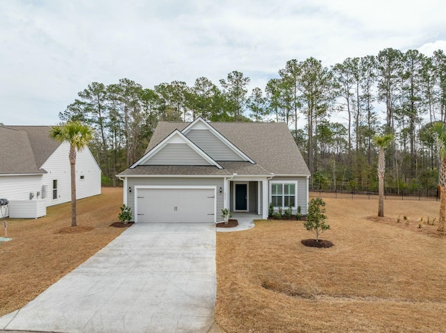 craftsman house featuring concrete driveway, a shingled roof, an attached garage, and fence