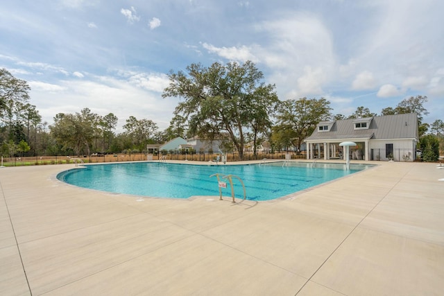 pool featuring a patio and fence