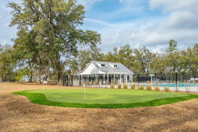 surrounding community with fence and a swimming pool