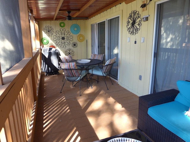 wooden deck featuring ceiling fan