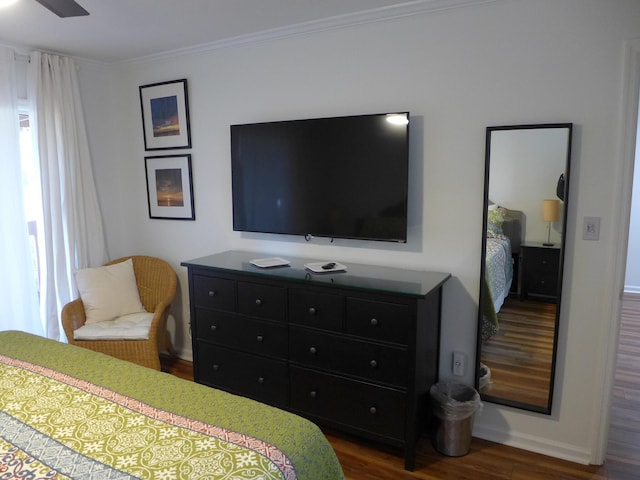 bedroom featuring dark wood-type flooring and crown molding