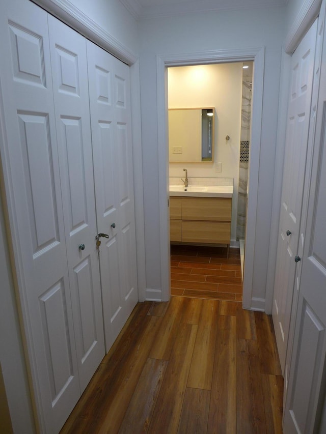 corridor featuring dark hardwood / wood-style floors and sink