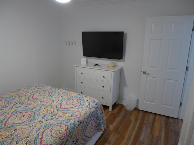 bedroom with dark wood-type flooring