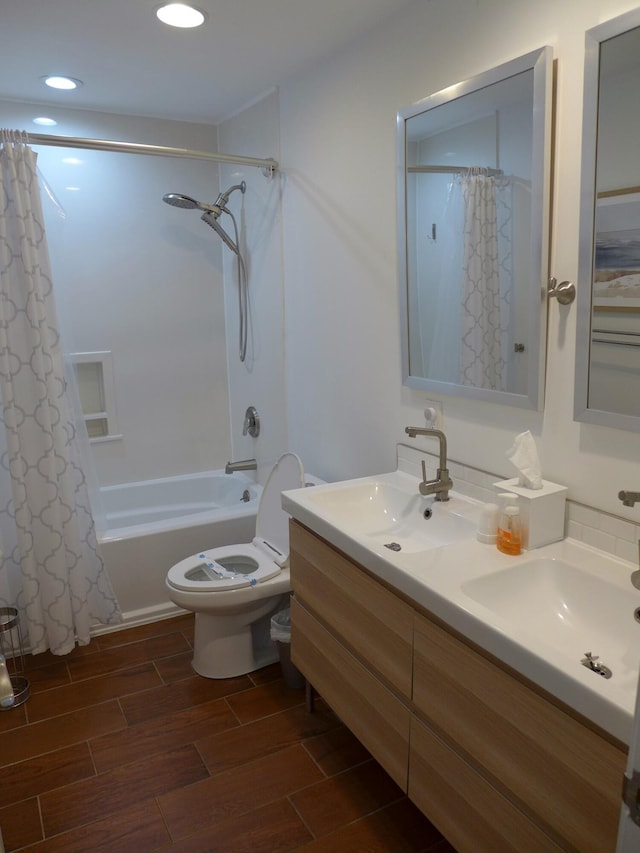 full bathroom with toilet, vanity, and shower / tub combo