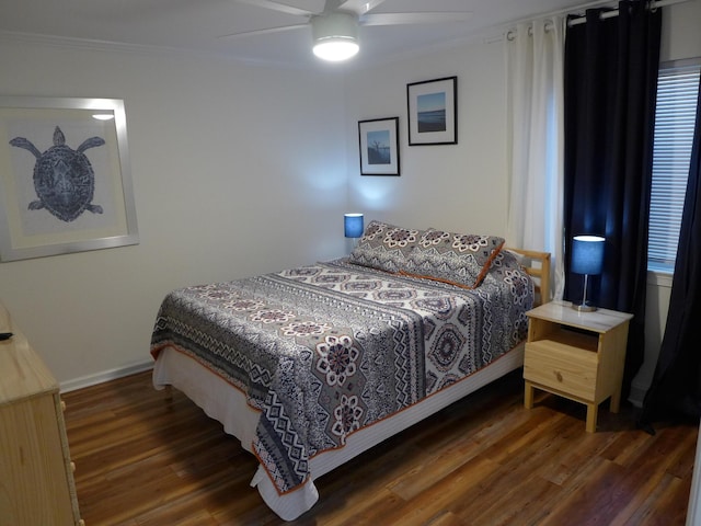 bedroom with ceiling fan, dark hardwood / wood-style flooring, and crown molding