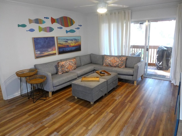 living room with ceiling fan, dark wood-type flooring, and ornamental molding