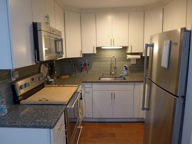 kitchen featuring stainless steel appliances and white cabinetry