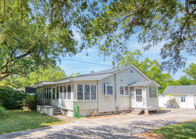 view of front of home featuring a sunroom