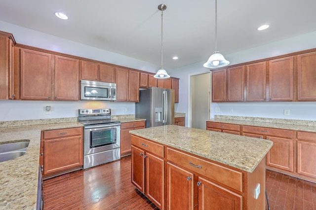 531 Crossland Dr, Moncks Corner, SC 29461 - kitchen featuring appliances with stainless steel finishes, a kitchen island, dark wood-type flooring, light stone countertops, and recessed lighting