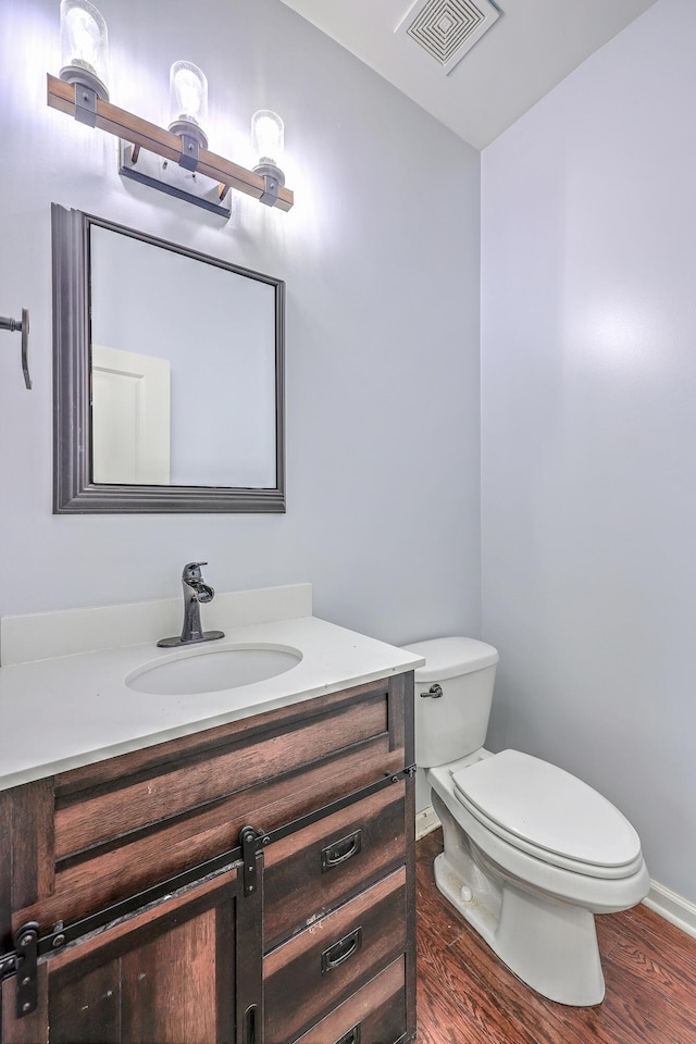 531 Crossland Dr, Moncks Corner, SC 29461 - half bathroom with vanity, toilet, wood finished floors, and baseboards