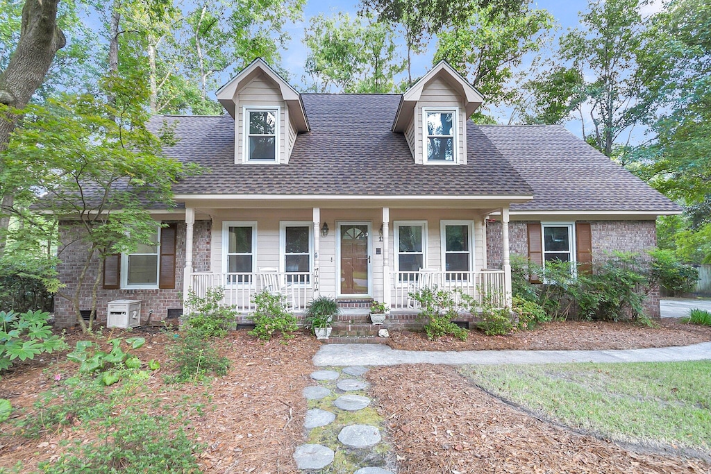 new england style home with a porch