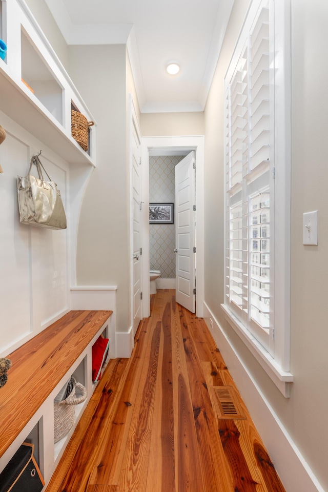 mudroom featuring crown molding and hardwood / wood-style floors