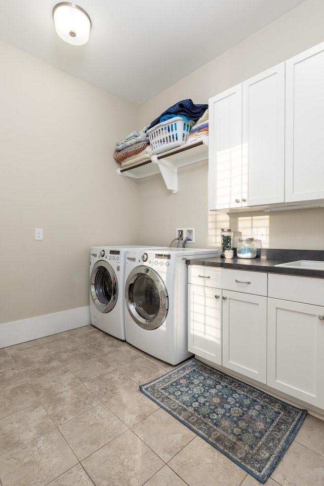 laundry room with independent washer and dryer and cabinets