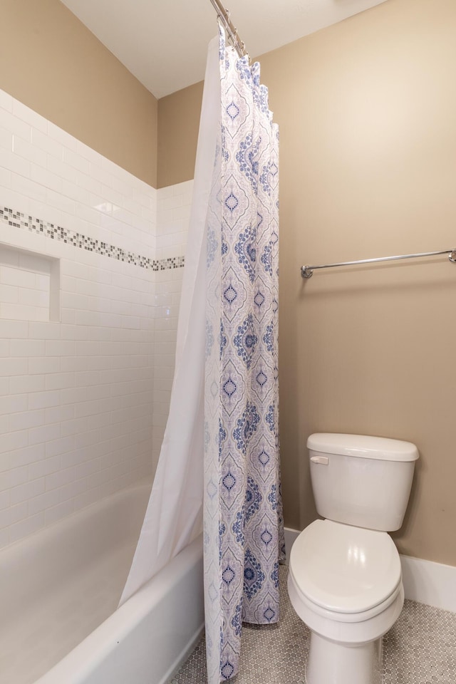 bathroom with shower / bathtub combination with curtain, toilet, and tile patterned flooring