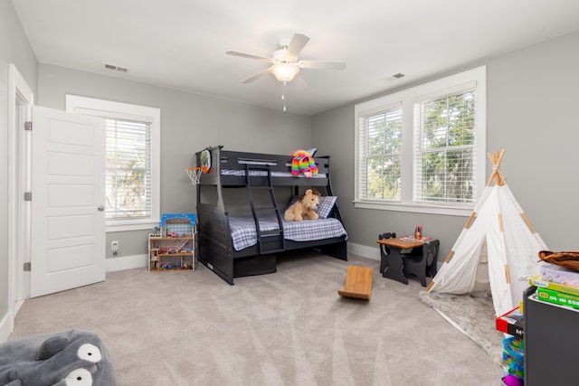 bedroom featuring light colored carpet and ceiling fan