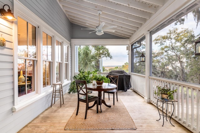 sunroom / solarium with lofted ceiling with beams and ceiling fan