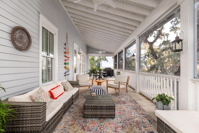 sunroom / solarium featuring vaulted ceiling with beams