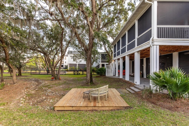 view of yard with a sunroom, a patio, and a deck