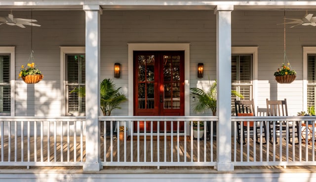 property entrance featuring a porch, ceiling fan, and french doors