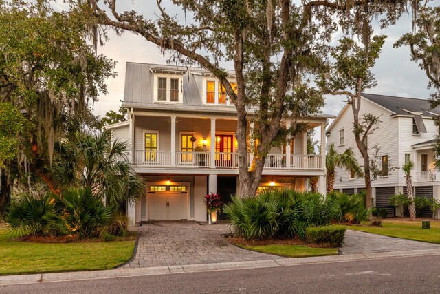 raised beach house with a balcony and a garage