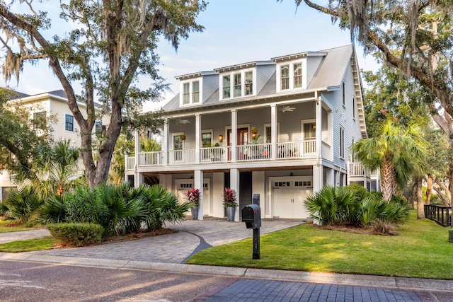 coastal home featuring a garage and a front yard