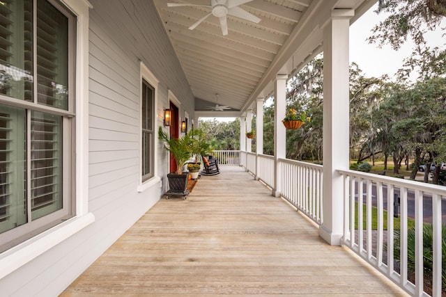 deck with ceiling fan and covered porch