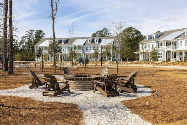 view of home's community with a fire pit and a residential view