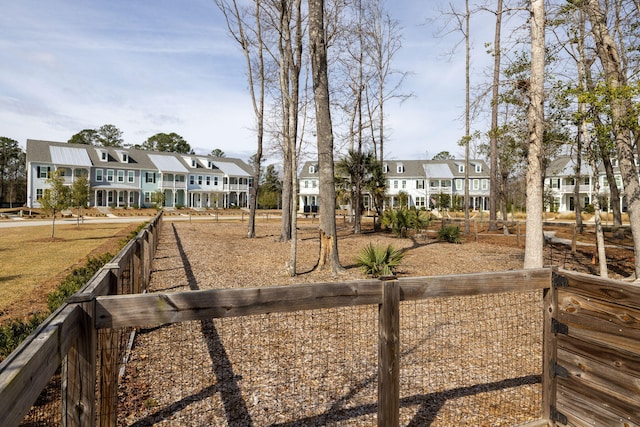 view of yard with a residential view and fence