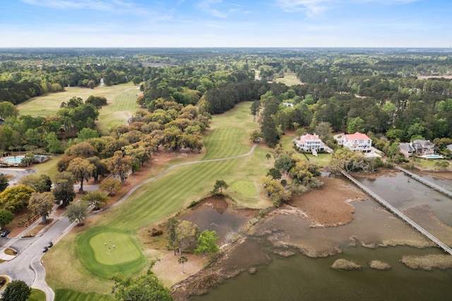 aerial view with view of golf course and a wooded view