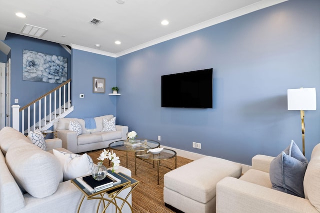 living area with baseboards, ornamental molding, visible vents, and recessed lighting