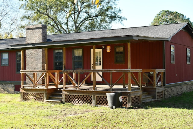 rear view of house with a yard