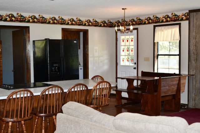 dining space featuring a chandelier and dark hardwood / wood-style flooring