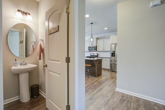 bathroom with hardwood / wood-style flooring