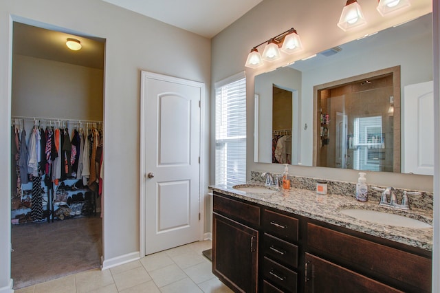 bathroom featuring tile patterned floors, vanity, and walk in shower