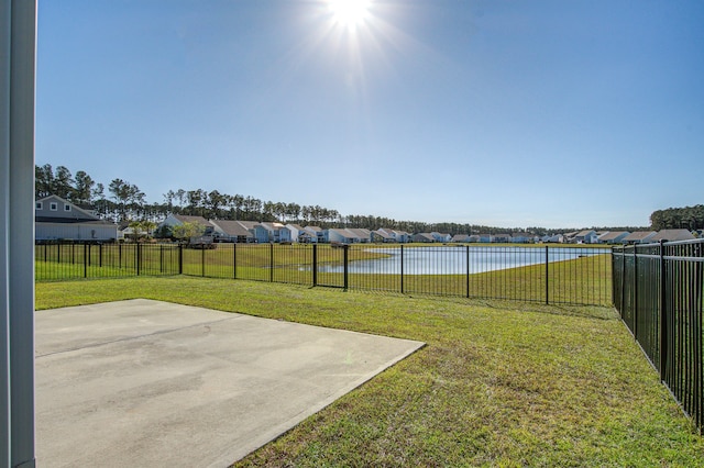 view of yard featuring a water view and a patio