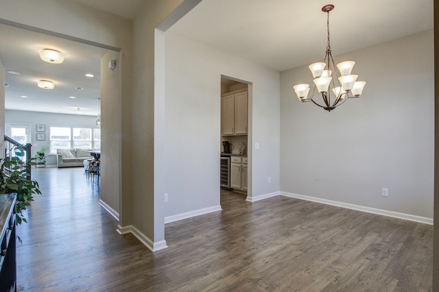 interior space with wine cooler, dark hardwood / wood-style flooring, and an inviting chandelier