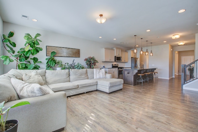 living room with light hardwood / wood-style flooring