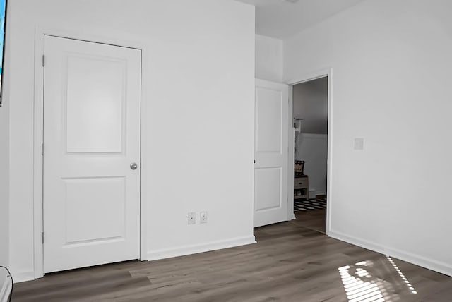 unfurnished bedroom featuring dark wood-type flooring