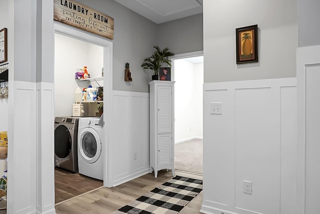 washroom with washer and dryer and light hardwood / wood-style floors