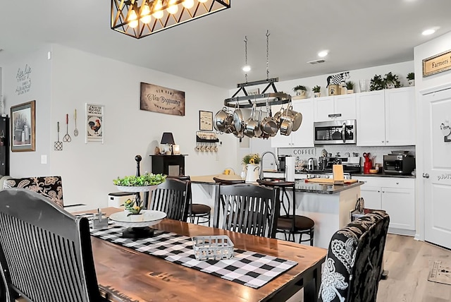 dining space with light wood-type flooring