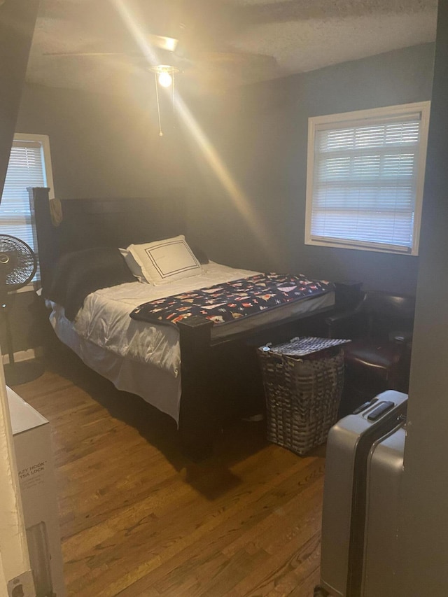 bedroom featuring ceiling fan and wood finished floors