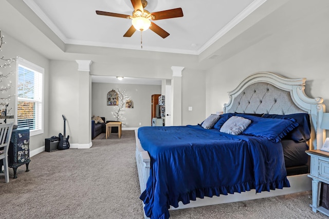 bedroom with ornamental molding, a tray ceiling, and carpet floors