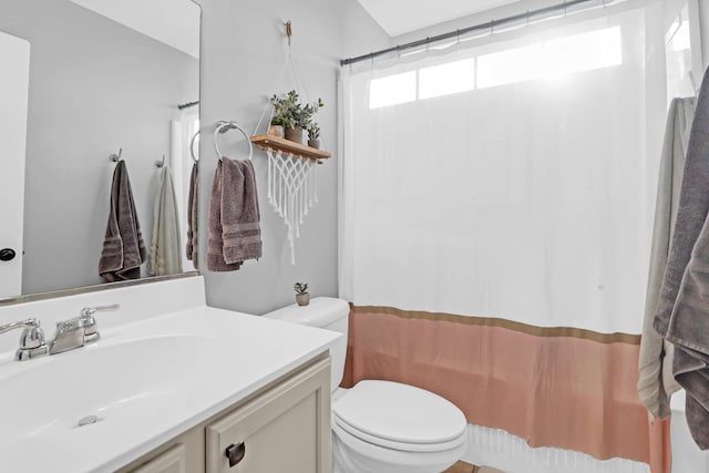 full bathroom with vanity, shower / bath combination with curtain, and toilet