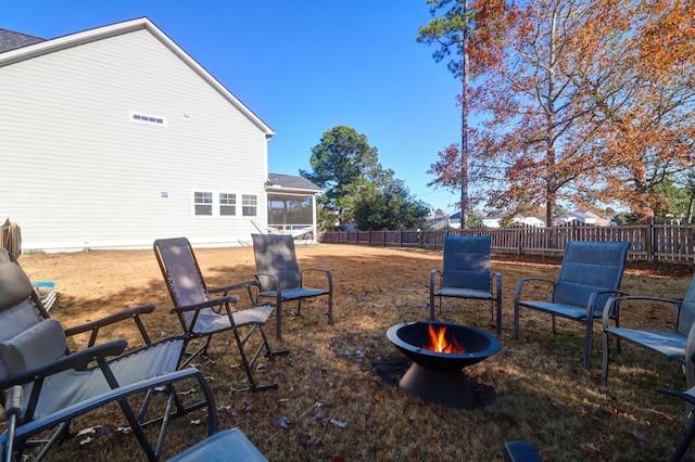 view of yard with a fire pit and a sunroom